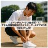 アキレス腱を押さえてうずくまる高校生男子スポーツ選手